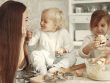 Happy family bonding while baking cookies in a cozy kitchen setting.